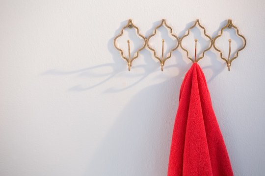 Close-up of red hoodie hanging on hook