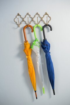 Colorful umbrellas hanging on hook