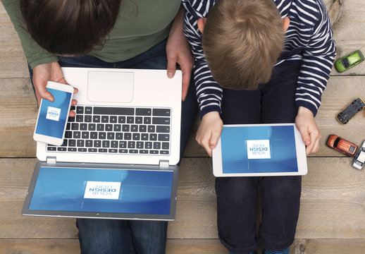 Top View Mockup of Mother and Son Sitting on Floor with Devices 2