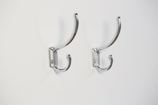 Empty hooks attached on wall