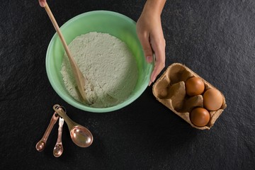 Woman mixing flour in bowl