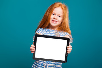 Naklejka premium Beauty little girl in tee shirt with long hair hold tablet