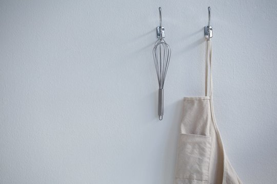 artist apron with paint brushes hanging on brick wall Stock Photo