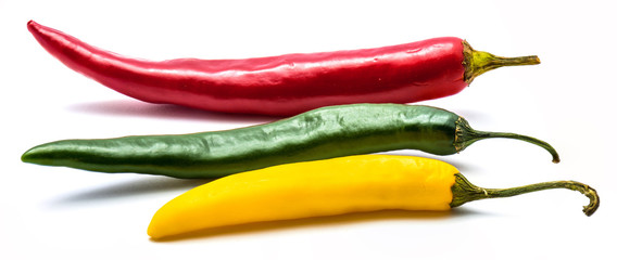 Red, green and yellow Cayenne Chili peppers isolated on white background whole
