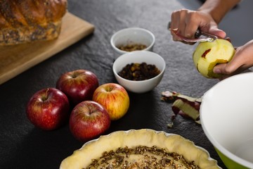 Woman pealing off apple skin