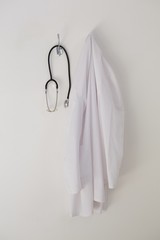 Laboratory coat and stethoscope hanging on hook