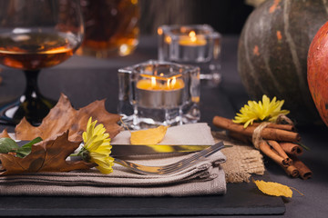 Table setting with autumn decoration for Thanksgiving.