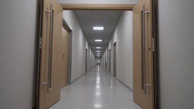 POV walking in a long white empty corridor interior