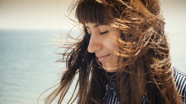 Woman relaxing while wind blowing through her hair