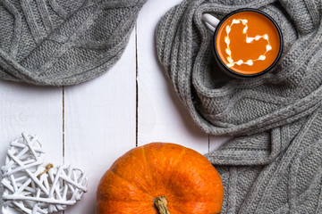 Favorite pumpkin soup in a mug. Warm autumn. Love warm. White wooden background. Top view. Flat lay