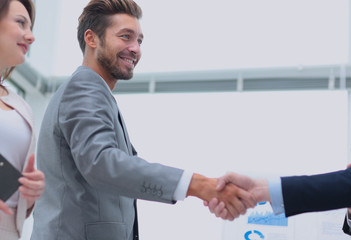 Two business people shaking hands with each other in the office