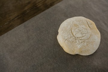 Dough ball pressed on butter paper