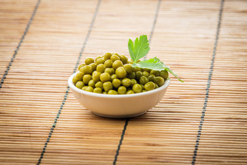 Canned peas.  Canned green peas.  Canned peas in a  plate