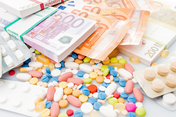 Money and pills. Pills of different colors on money. medicine concept. Euro cash