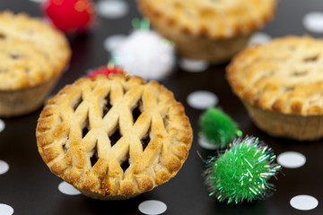 Lattice top mince pies against a christmas background