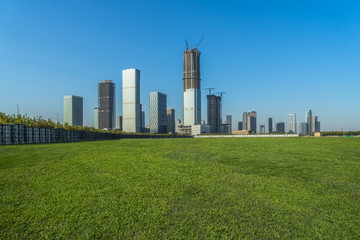 Fototapeta na wymiar green lawn with city skyline background, tianjin, china