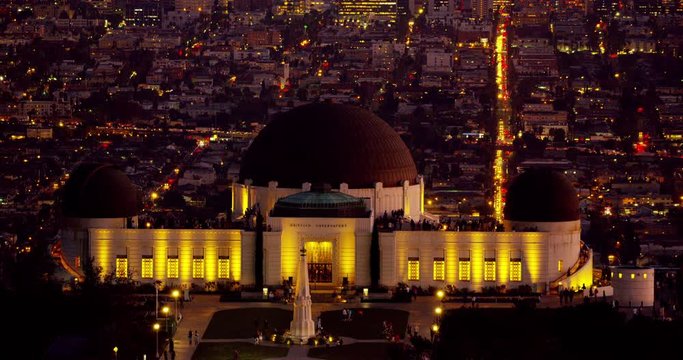 Telephoto shot at night of The Griffith Observatory and LA skyline in the distance in Los Angeles, California.