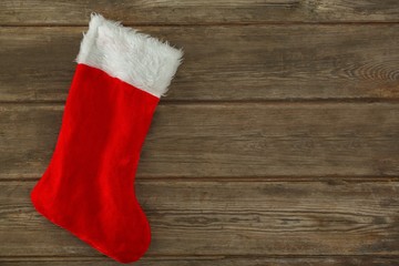 Obraz na płótnie Canvas Christmas stocking on wooden plank