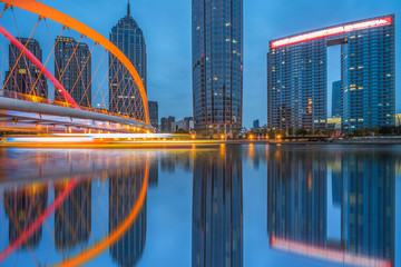 Tianjin city waterfront downtown skyline with Haihe river at dusk,China.