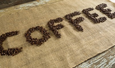 Word coffee arranged with coffee beans