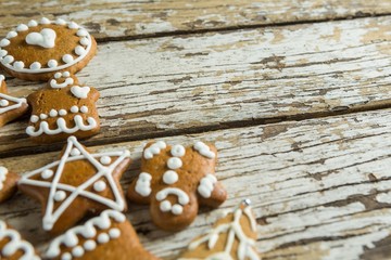 Gingerbread cookies arranged on wooden plank