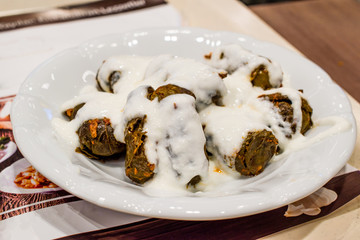 Turkish Dolma with Yogurt / Stuffed Grape Leaves with Rice and Minced Meat.