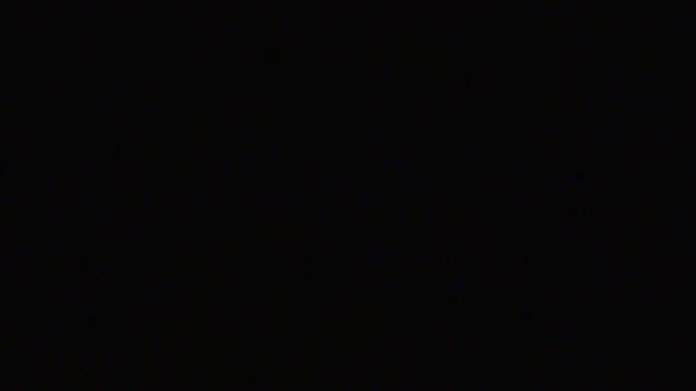 Man lights up and holds a lighter in the darkness. Lighter sparking in a male hand. Recorded at 96 fps, Running at 25fps, Slow Mo. 