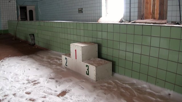 Swimming pool in building of Palace of Culture and Sports in Pyramiden Arctic. Russian neglected township on Spitsbergen . Canned place times of Soviet Union. Time stood still of North Pole.