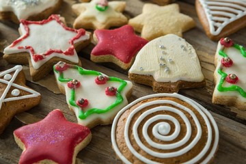 Gingerbread cookies arranged on wooden plank