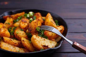 Appetizing countryside homemade meals. Eating delicious roasted potatoes. Home food close up