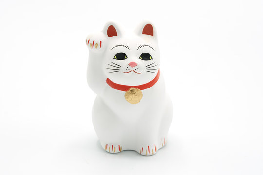 a Maneki-neko ceramic cat, Symbolizing luck and wealth, on a white background