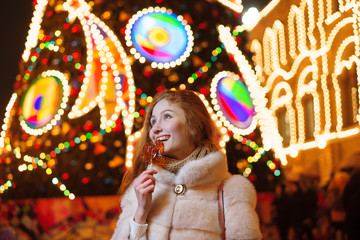 red-haired girl on the background of a Christmas tree