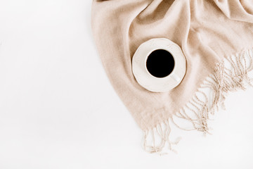 Cup of coffee on pale beige pastel plaid. Flat lay, top view