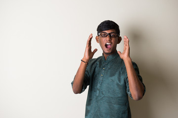 teenage indian male in traditional dress shouting