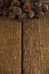 Pine cones on wooden plank