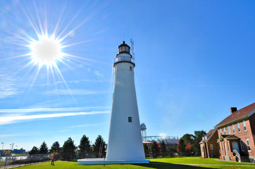 A tall lighthouse protects the river entrance for ships entering from the lake