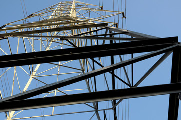 An electrical tower from below conveys a sense of height and power