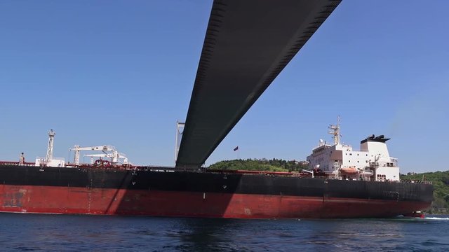 Cargo ship sails under the Bosphorus Bridge, Turkey 