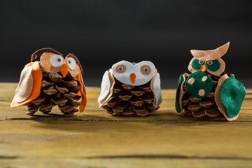 Close up of owl made with pine cones