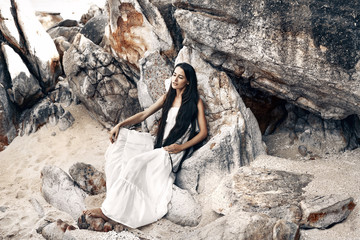 beautiful young boho style woman in white dress