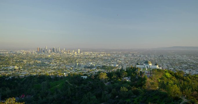 The Griffith Observatory and downtown LA skyline in the distance in Los Angeles, California.