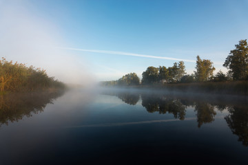 Foggy morning on autumn river background.