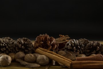 Close up of walnuts with pine cones and cinnamon stick