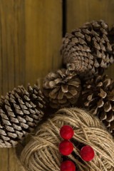 Directly above shot of pine cones with thread spool with push