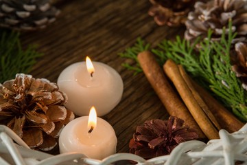High angle view of pine cones with illuminated candles and