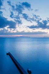 Top view of jetty or pier in blue color tone on evening time 