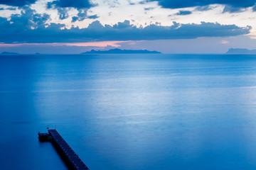 Top view of jetty or pier in blue color tone on evening time