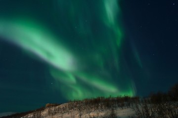 Fototapeta na wymiar The Northern lights ,Aurora the night over the hills and forest.