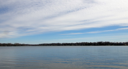 The wide sky over a calm lake in the woods