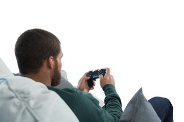 Man playing video game against white background